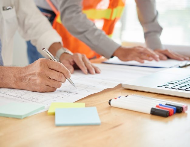 Close-up image of engineer making marks on blueprint